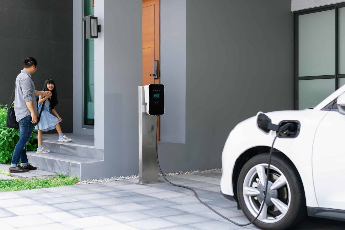 progressive-dad-daughter-charging-ev-car-from-home-charging-station-full_normal.jpg